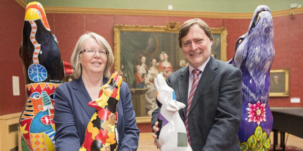 Cllr Claire Darke, Wolves in Wolves artist, and Cllr John Reynolds with two of the mini wolves
